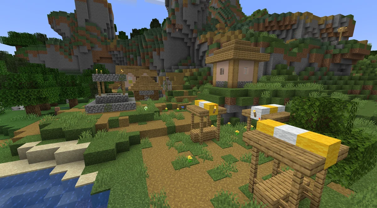 Fast Better Grass author village scene showing green block sides and path edges on a hillside