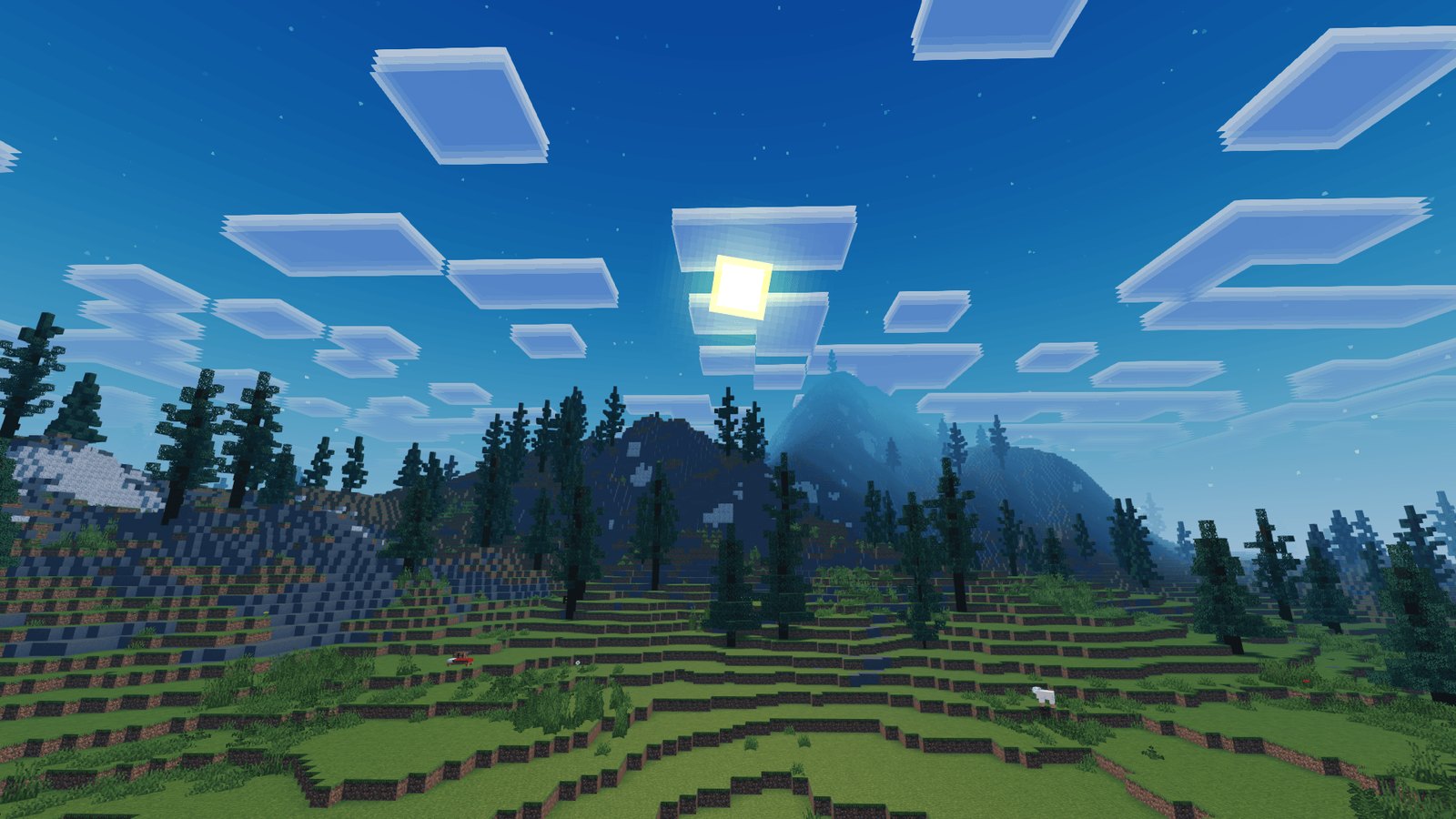 Bright square sun and layered clouds above spruce trees and mountain slopes
