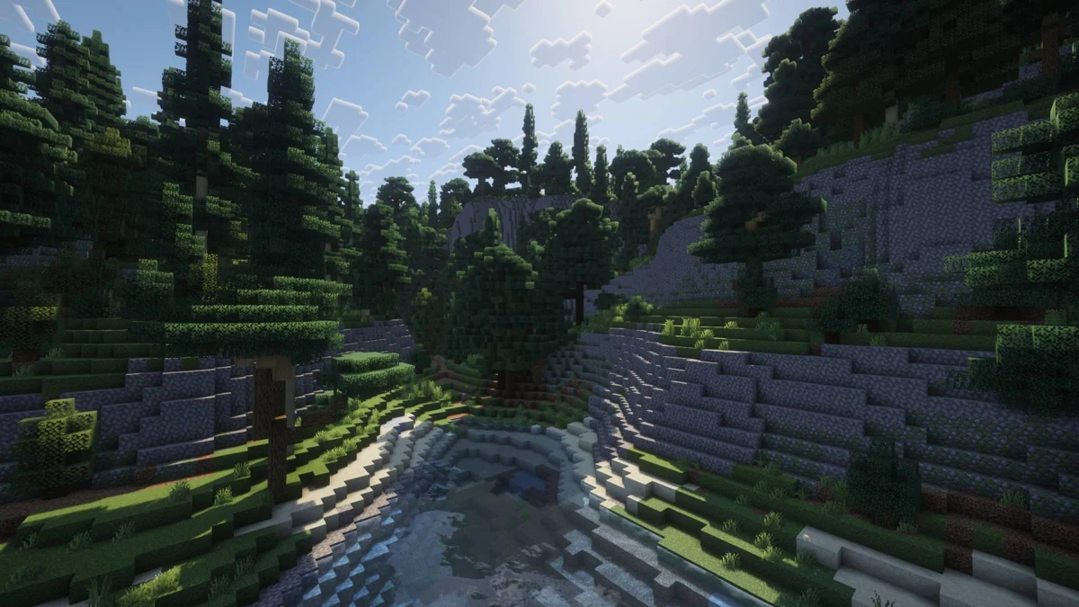A wooded waterway between stone slopes