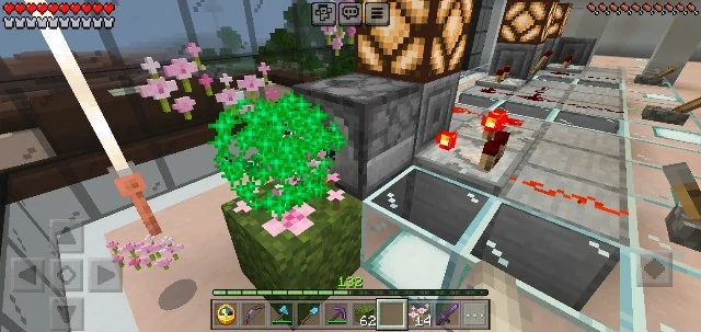 Pink petal items and bone meal particles in front of a dispenser