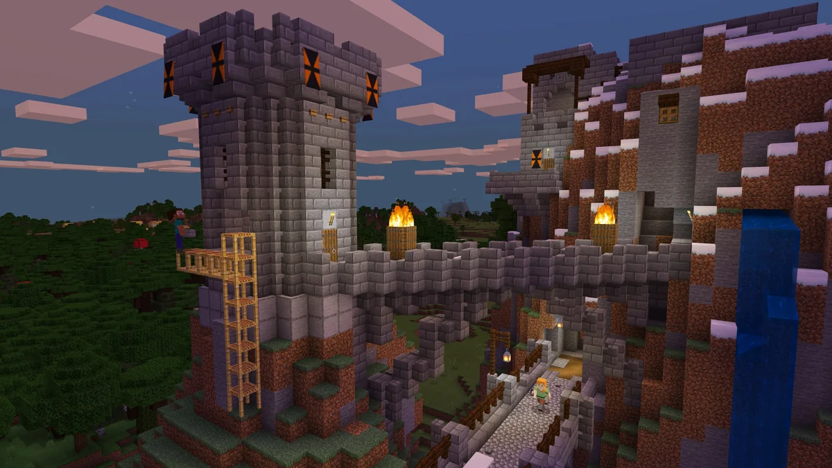 Minecraft castle under construction with scaffolding, a waterfall and players