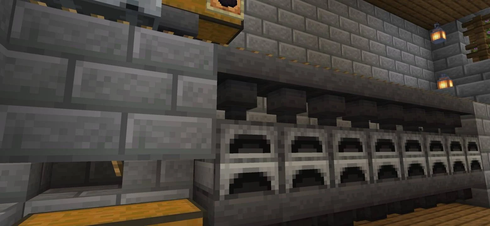 Row of furnaces with hoppers and nearby chests in a stone-brick workshop