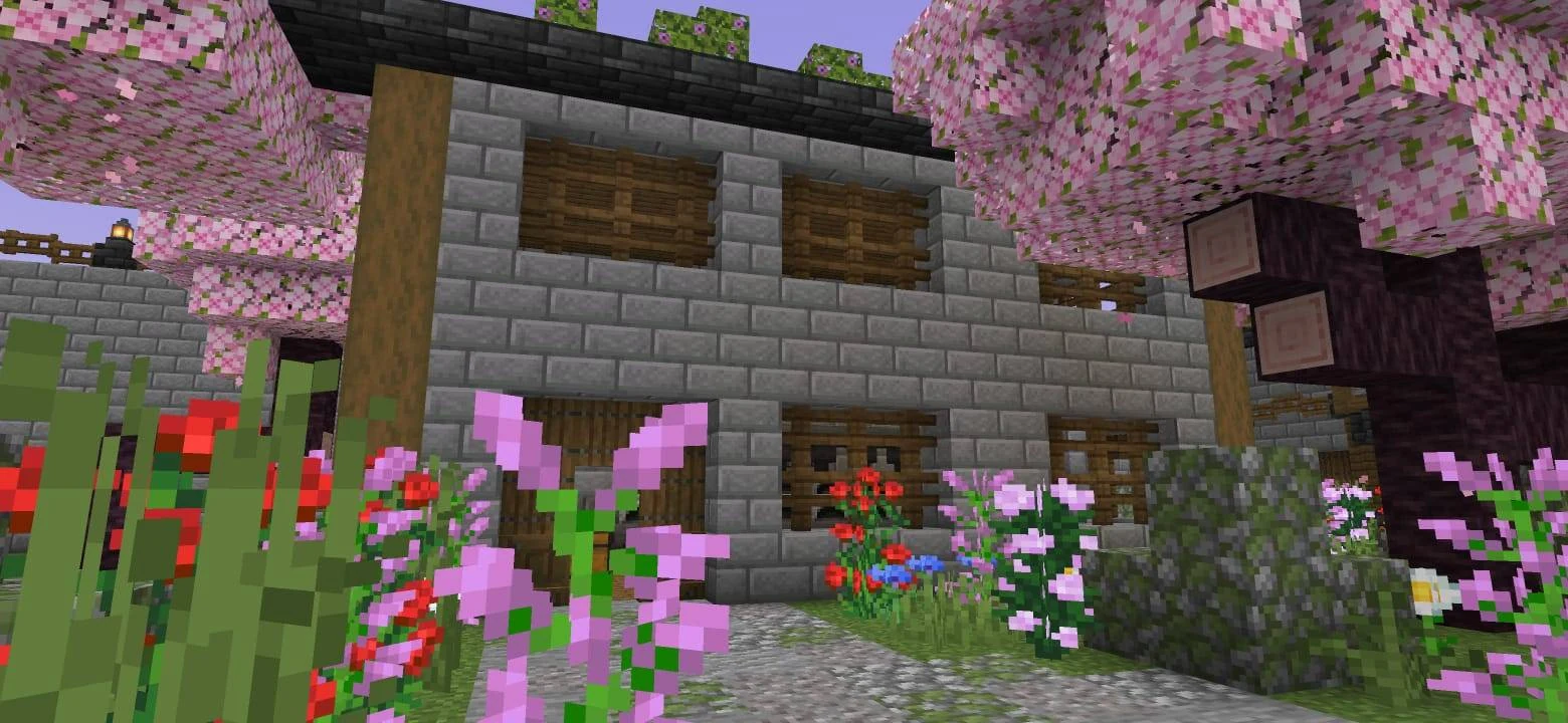 Two-storey stone-brick house with wooden pillars, shutters and dark roof