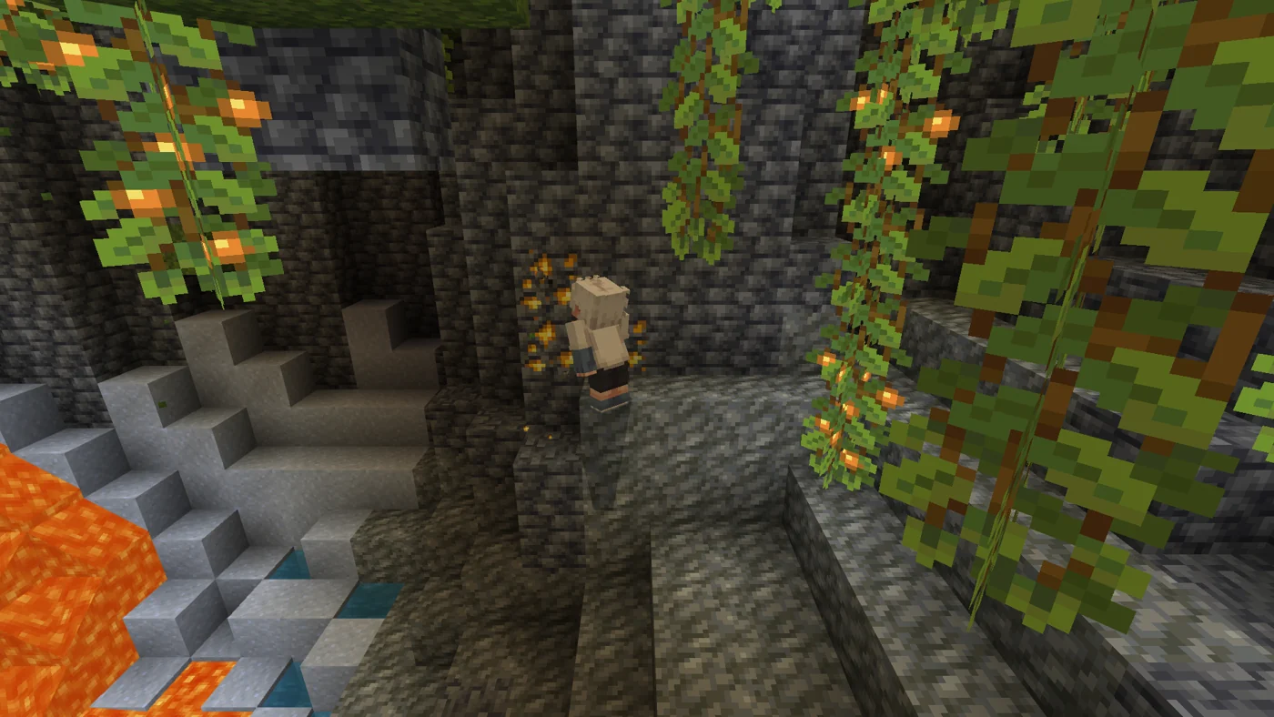 Player mining exposed ore in a lush cave