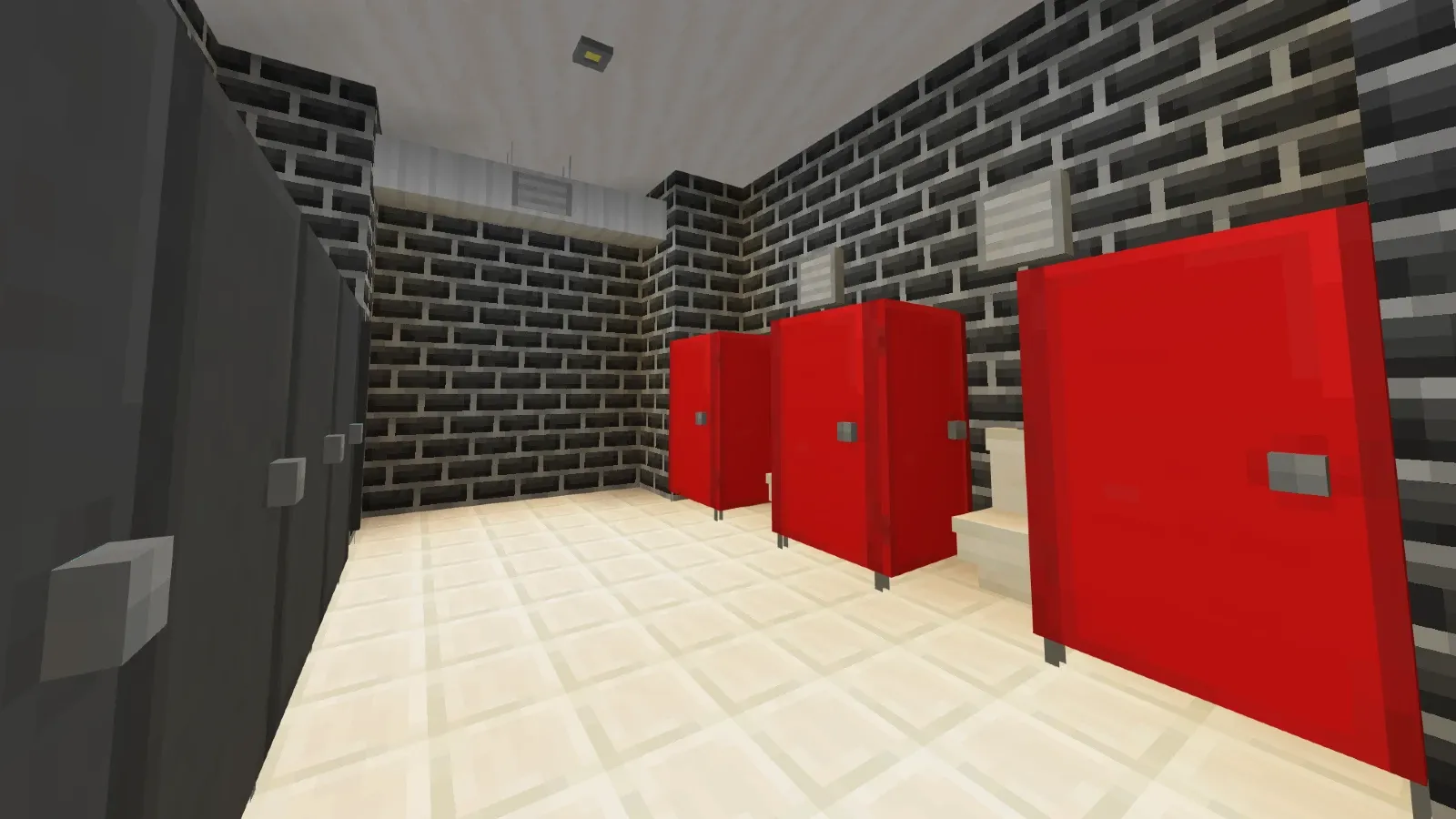 Row of red bathroom partitions beneath ventilation ducts in Modern Furniture