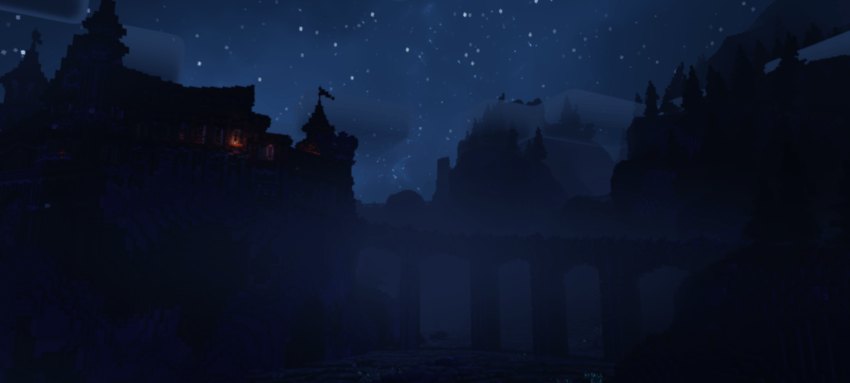 Dark lake and distant lit building beneath a starry night sky