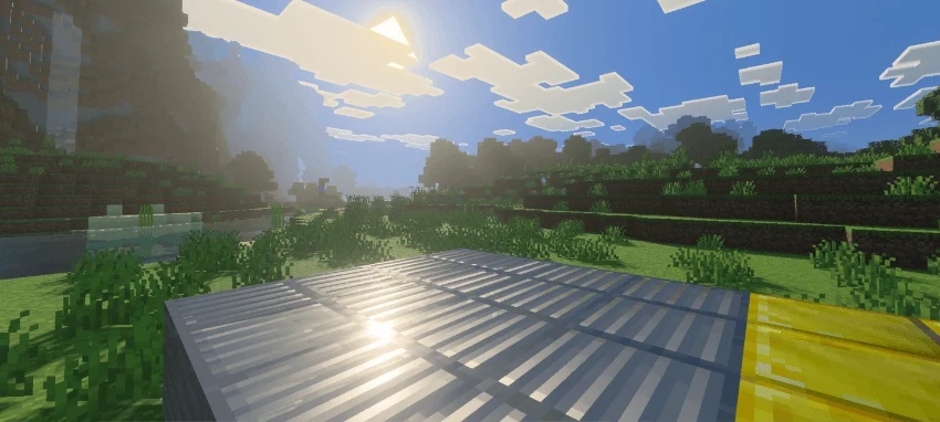 Sunlight shining on metallic-looking blocks beside a gold block