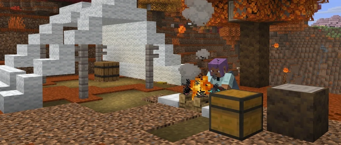 Efe sits beside a campfire at an abandoned camp surrounded by autumn-colored poplar trees