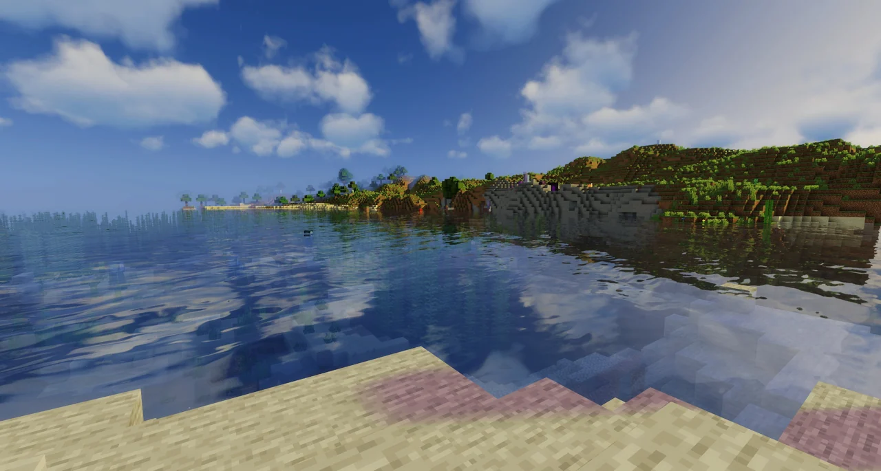 Sunlit Minecraft lake with sky reflections and a clear shoreline
