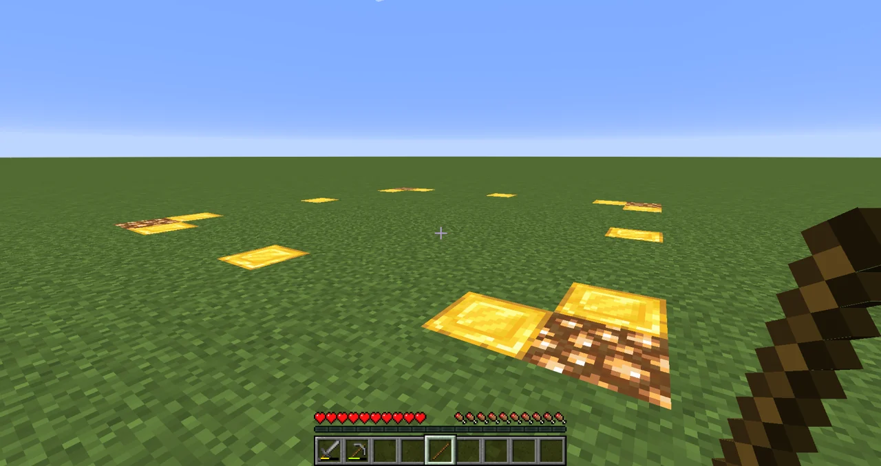 Minecraft claim outline shown with temporary gold and glowstone markers while a player holds a stick