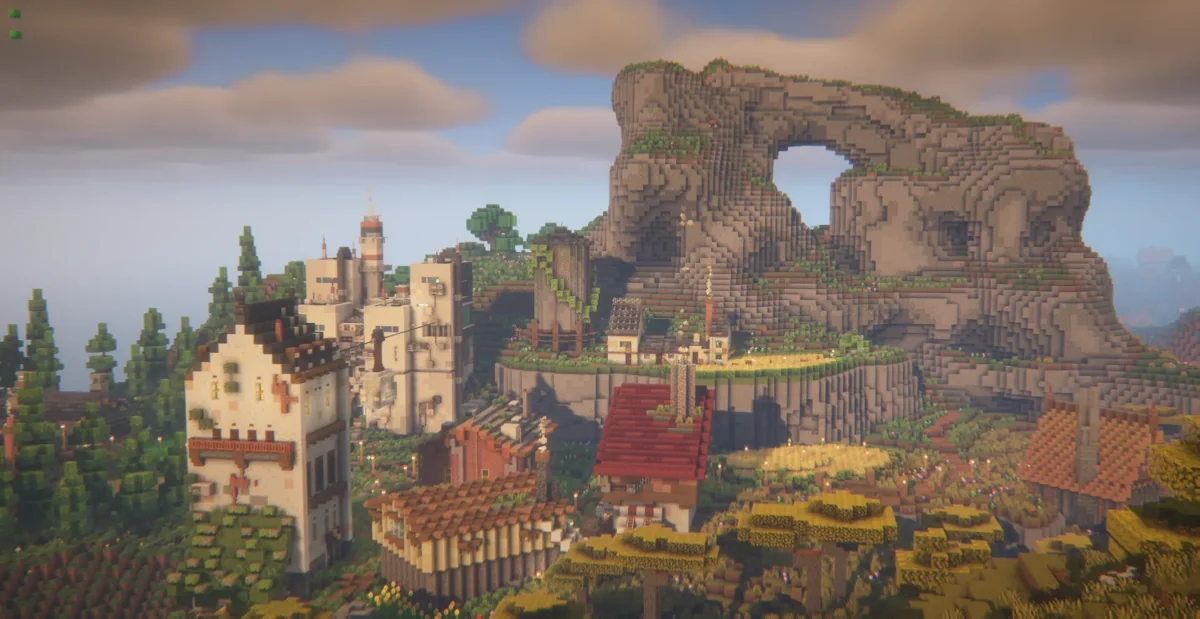 Minecraft Town author screenshot showing buildings below a large mountain arch
